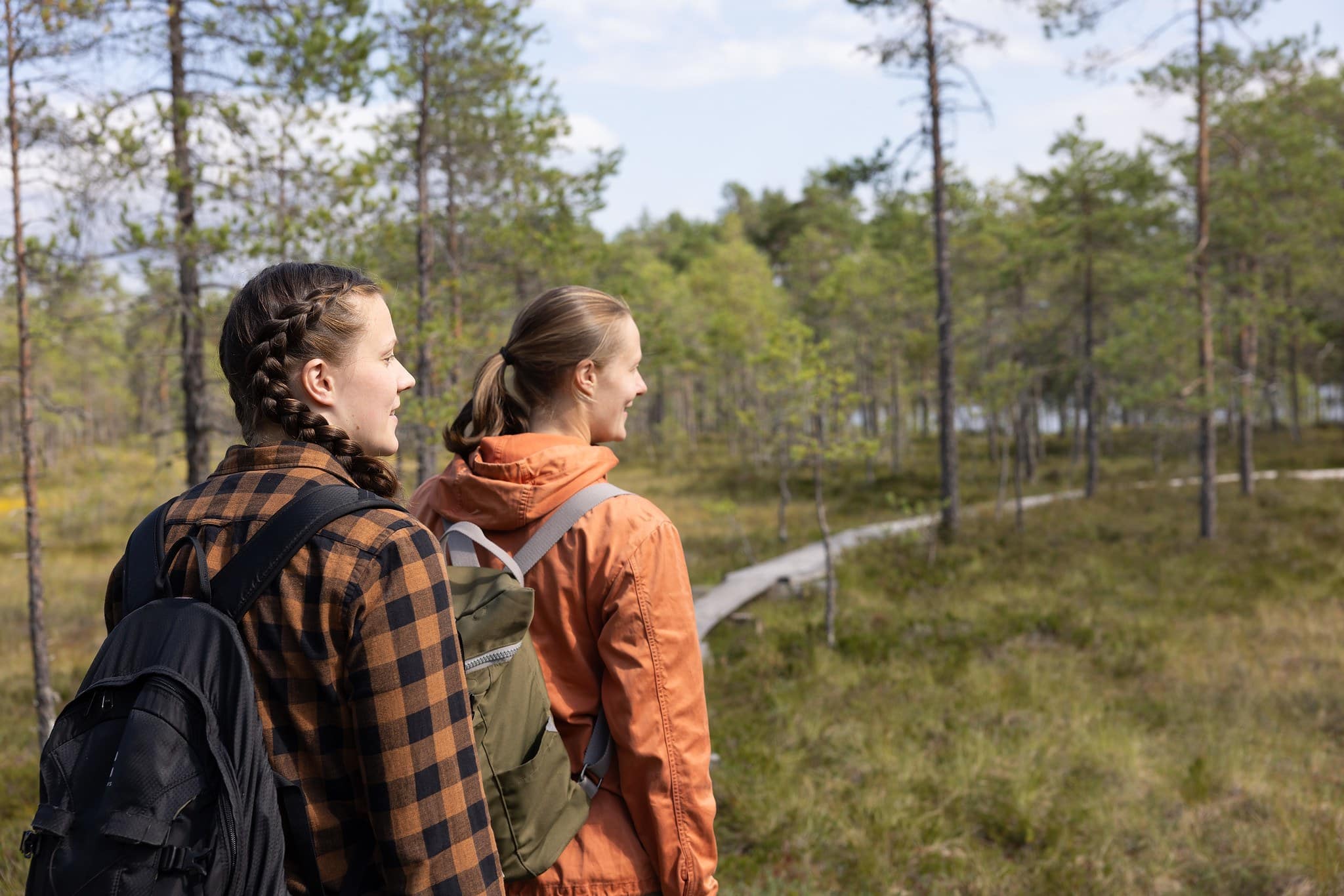 Two women walking on duckboard at Komio Nature Reserve.