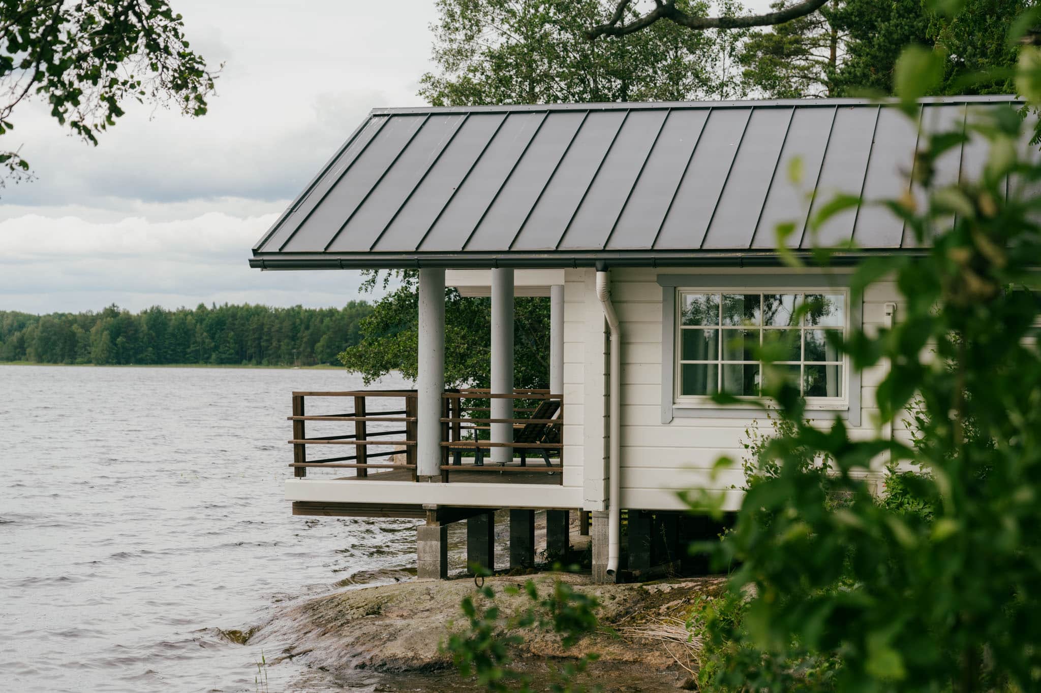 A white cottage by the lake.